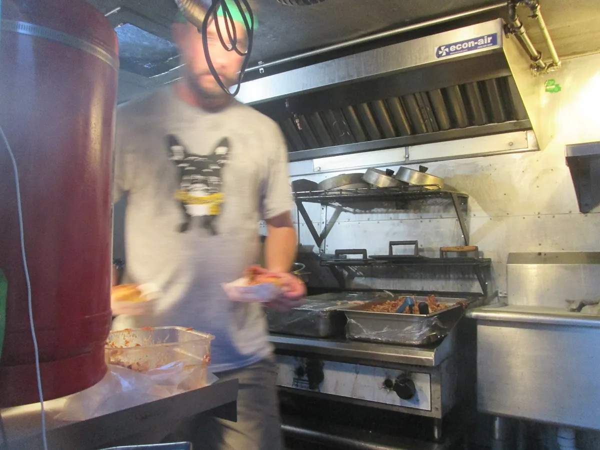 Food truck hood cleaning Huntsville AL example: a stainless food truck hood with baffle filters over the fryer and flat-top