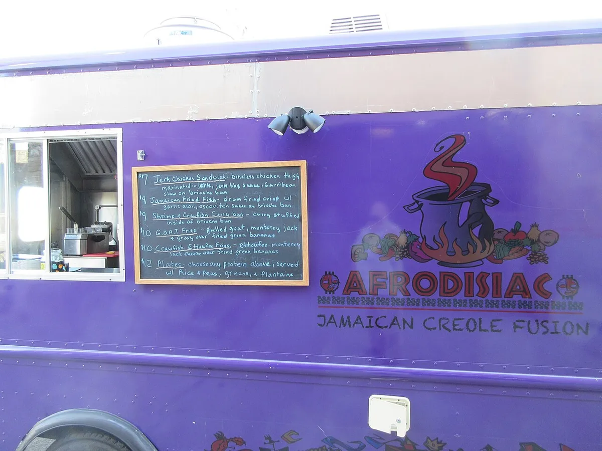 Food truck hood cleaning Huntsville context: a food truck's service window and menu board, with the hood line behind the window