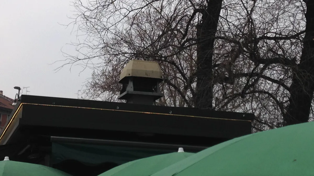 Restaurant exhaust fan repair Huntsville AL: a rooftop mushroom-cap exhaust fan on its curb at the roof edge